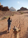 CAMEL GUIDE IN WADI RUM, JORDAN